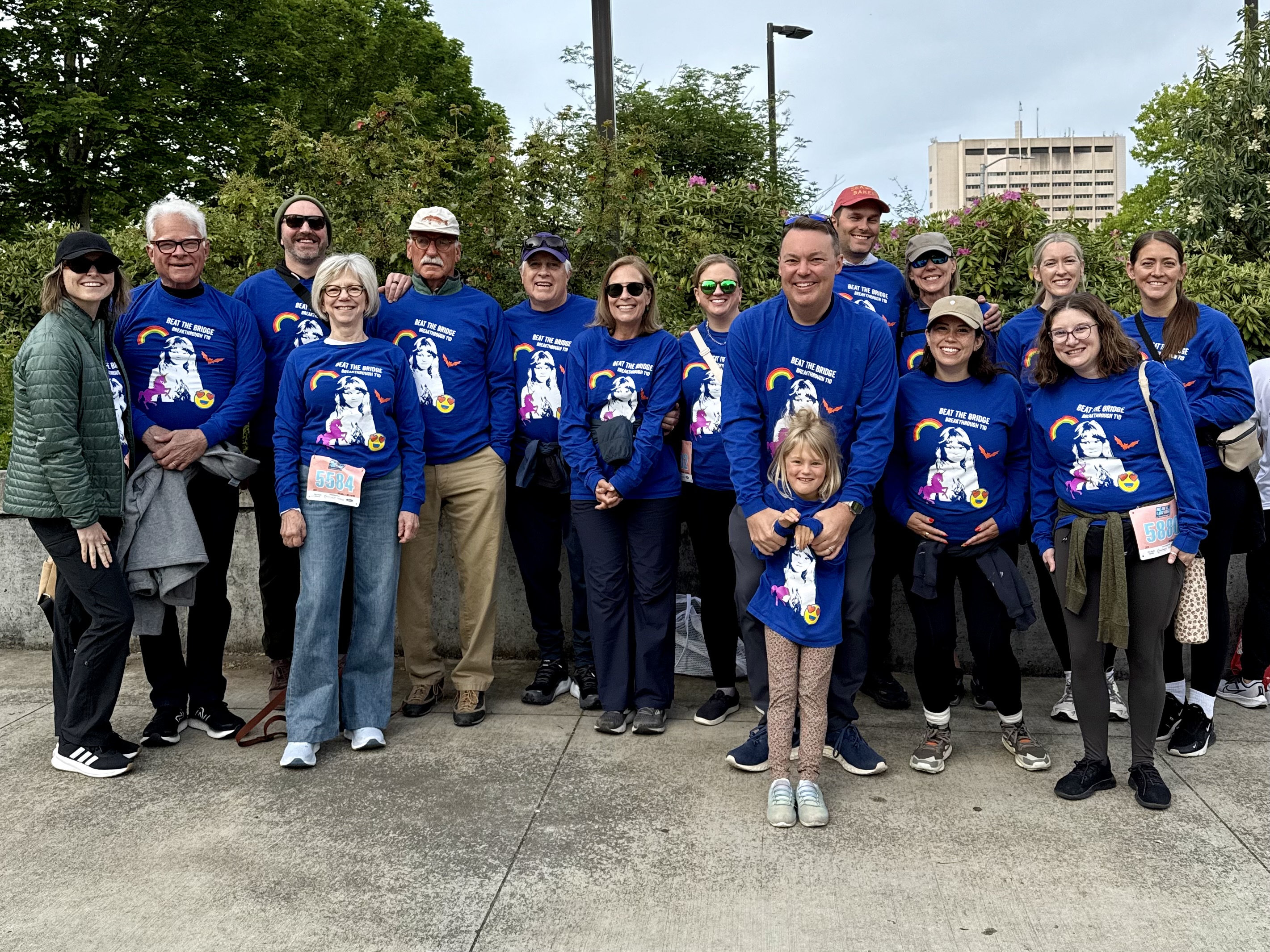 Team Wulff at the 43rd Annual Beat the Bridge in May 2025, about seventeen people in matching blue Beat the Bridge t-shirts with Abigail in front