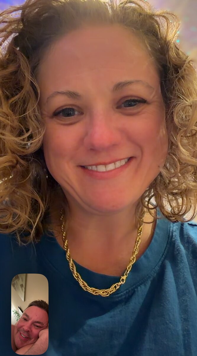 A FaceTime call with Courtney smiling on screen and me in the corner tile, resting my head on my hand.