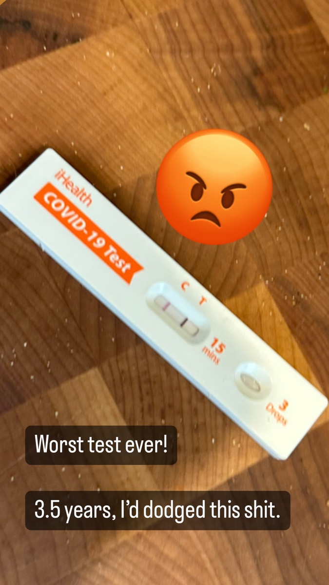 An iHealth COVID test with a positive line and an angry emoji, captioned "Worst test ever! 3.5 years, I&rsquo;d dodged this shit."