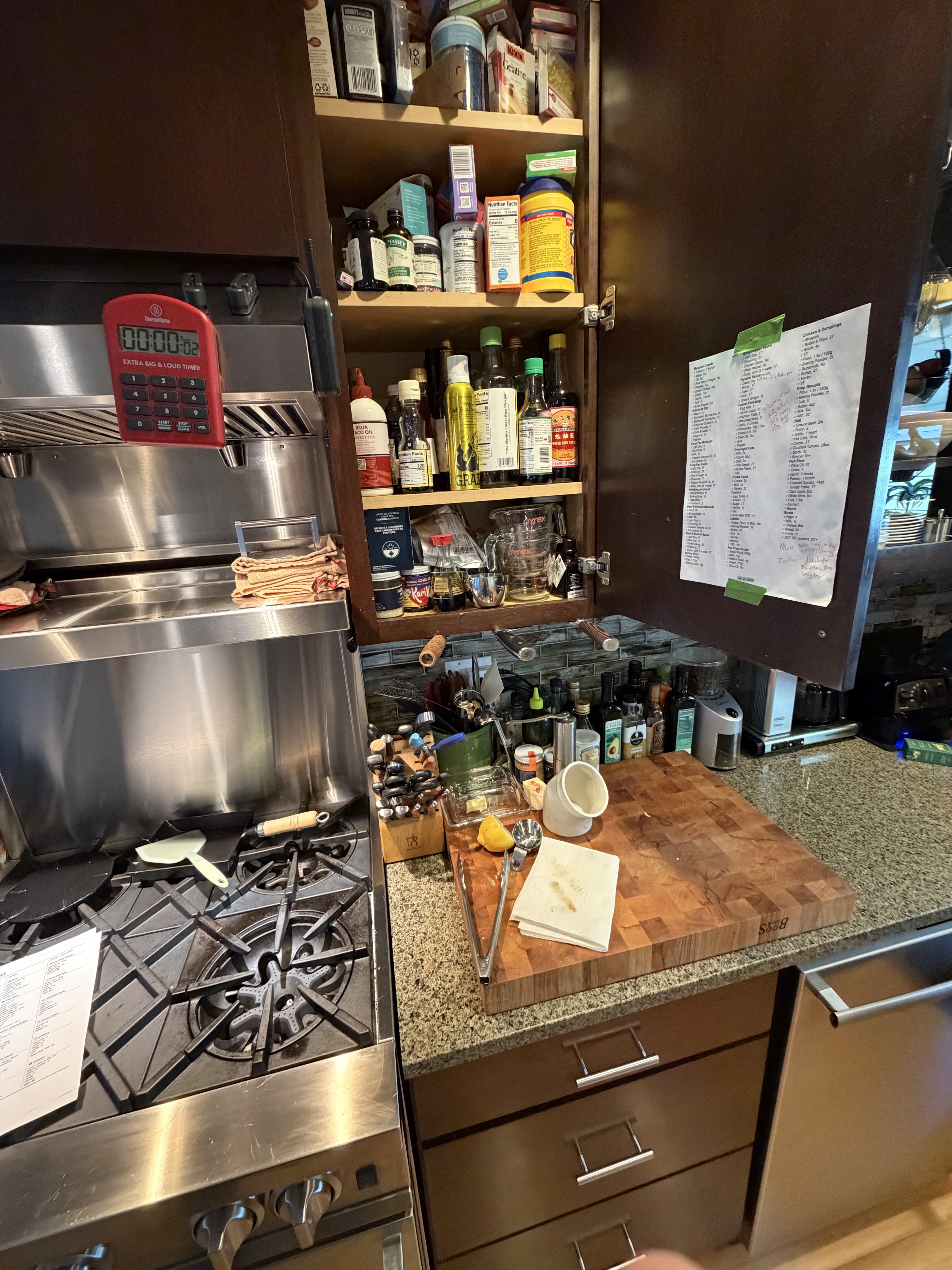 The old crib sheet taped inside the open kitchen cupboard beside the stove.