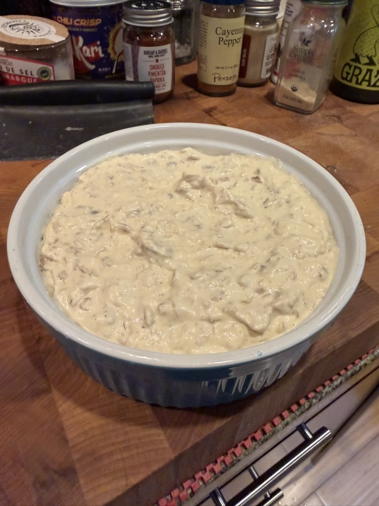 Finished onion dip in a serving dish ready for chilling