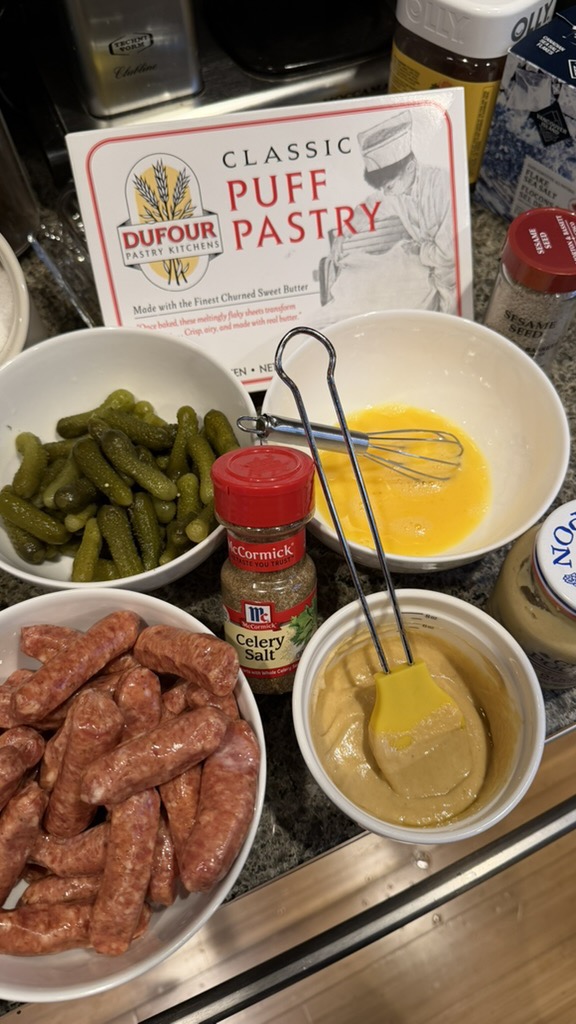 Mise en place with Dufour puff pastry, Beeler's Li'l Bites, cornichons, Grey Poupon, egg wash, and celery salt