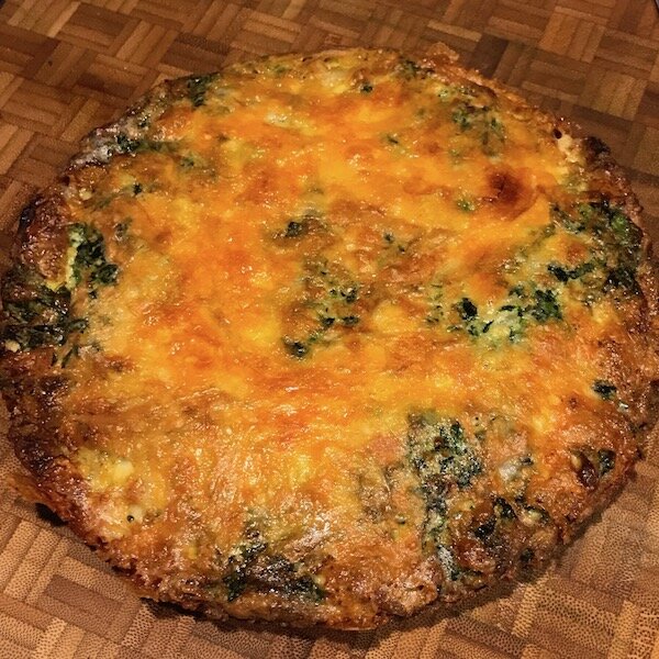 Finished spinach frittata with golden cheesy crust